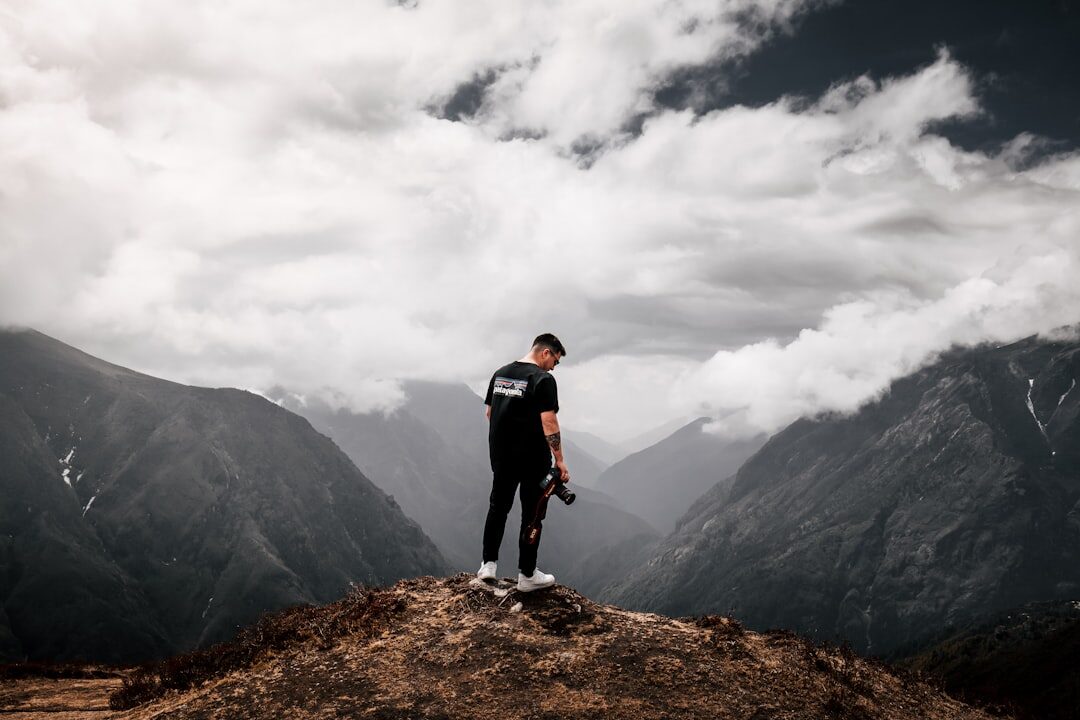 person standing confidently on mountain